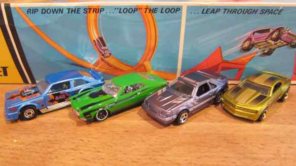 l to r: blue Flat Out 442, green '72 Ford Gran Torino Sport, violet "84 Mustang SVO and a gold Chevy Camaro Concept.